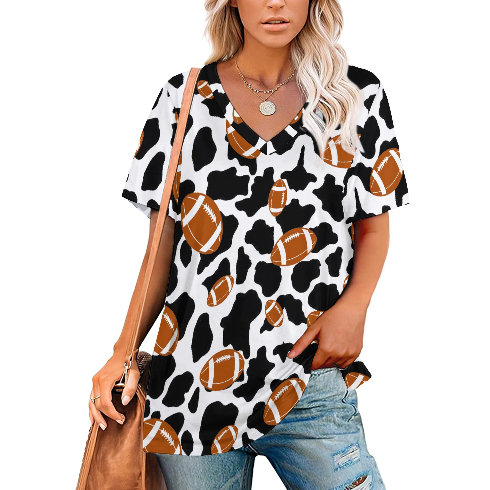 Women's V-Neck Short Sleeve Tee in Footballs And Cow Spots print – front view on model