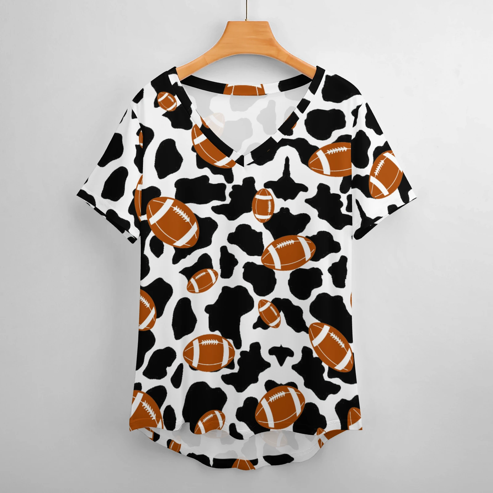 Women's V-Neck Short Sleeve Tee in Footballs And Cow Spots print – front view on hanger